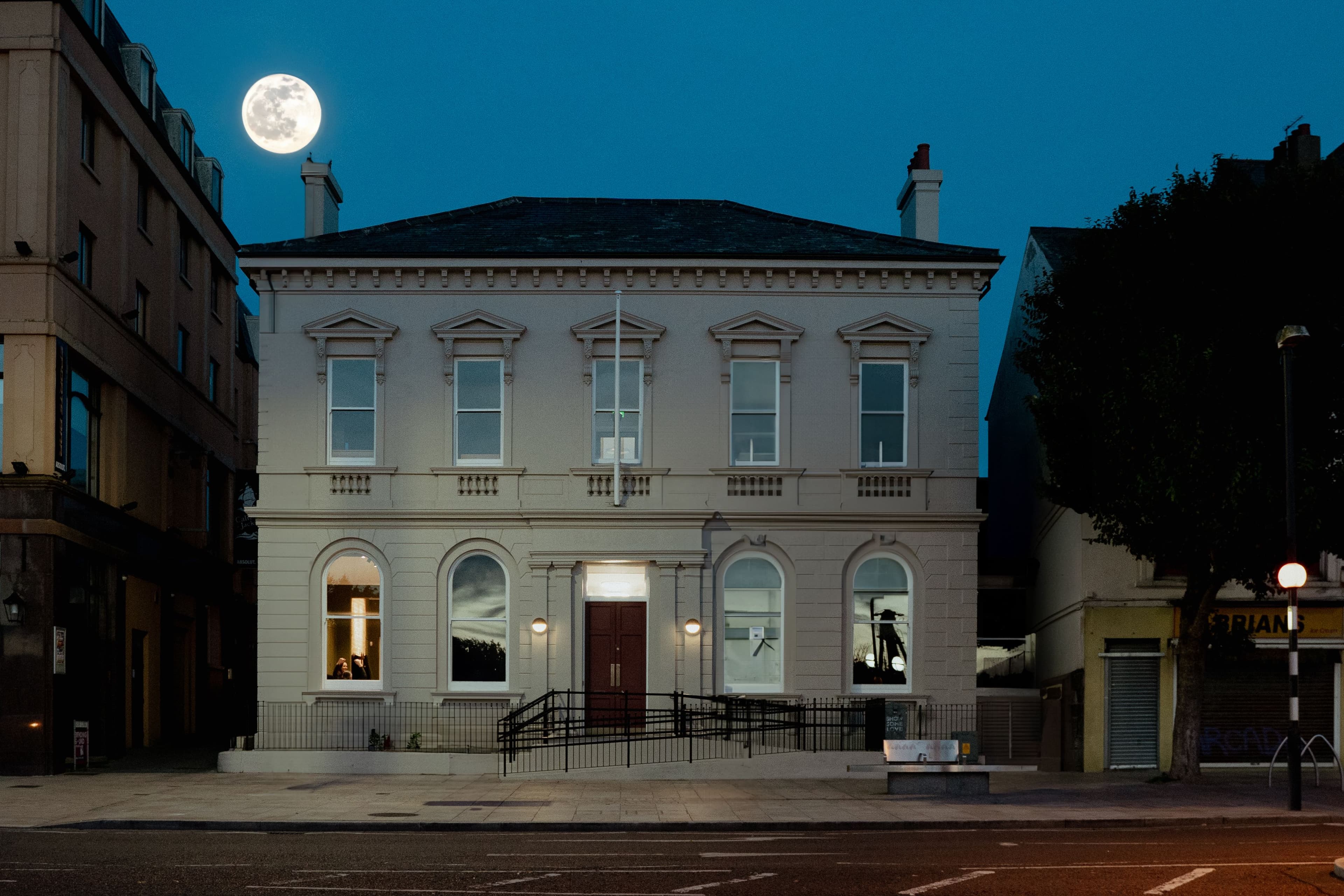 A photograph of the exterior of Bangor Court House at night.