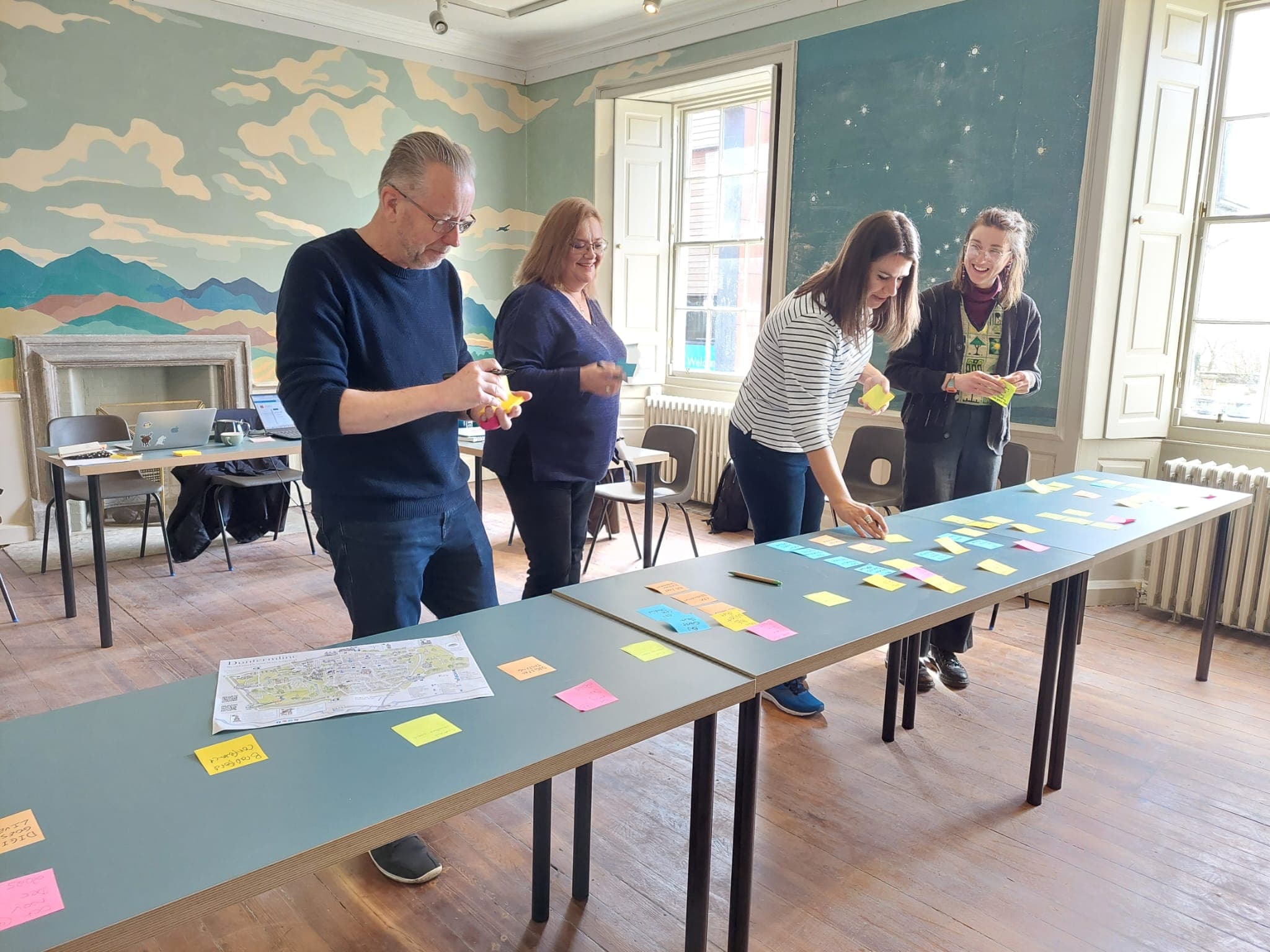 Staff members map out plans for the Network on colour paper.